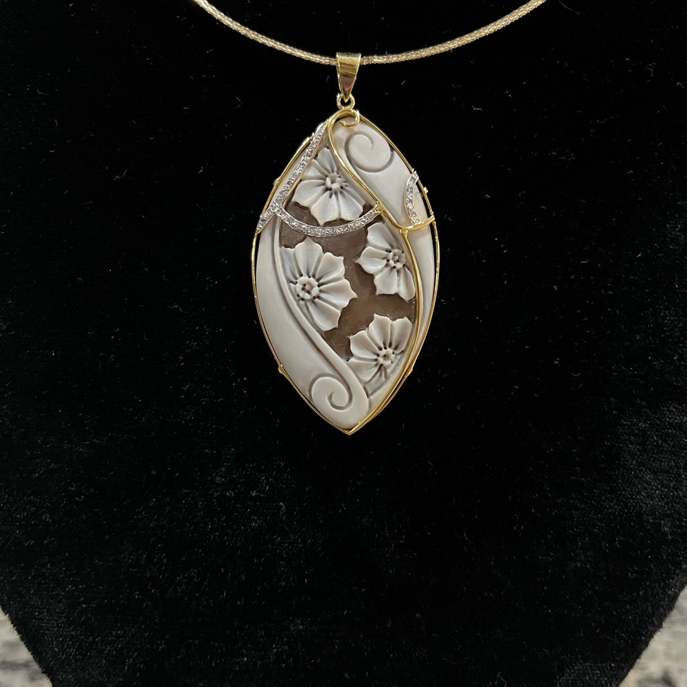 Beautiful cameo set in 14k yellow gold with diamonds. approximately 9 grams.